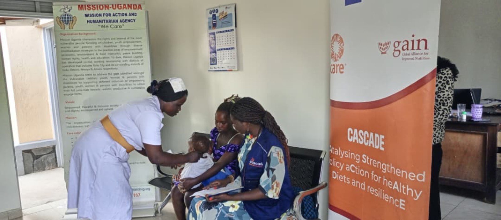 CASCADE health worker examining a child during outreach
